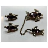 Gold tone purple and clear rhinestone brooches