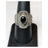 Silver black onyx Ring marked 925.    Size 7