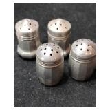 Silver salt and pepper shakers marked Sterling.