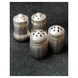 Silver salt and pepper shakers marked Sterling.