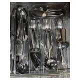 Plastic utensil tray filled with flatware and