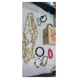 Small painted musical jewelry box with bracelets