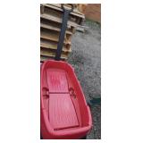 Red plastic two seater radio flyer wagon