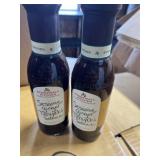 Two bottles of sesame, ginger, teriyaki sauce,