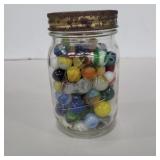 Assorted marbles in pint glass jar