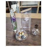 Geoyp of three decorative oil lamps and glass