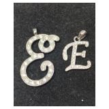 2 silver tone " E" clearstone pendants