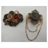 2 button style brooches