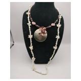 Dark shell medallion with accent shell flowers