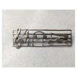 Silver music signs brooch unmarked.   .165oz