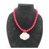 Red coral bead with carved flower pendant