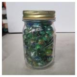Pint jar of mostly cats eye marbles