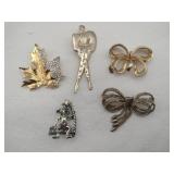 Gold tone brooches leaf, bows ,monkey, person