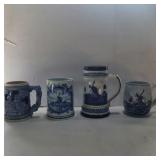3 blue delft steins and 1 blue and white stien