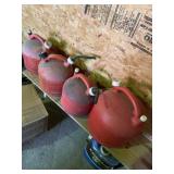 Three 2 1/2 gallon eagle gas cans and one 5