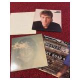 Four vinyl albums, including Beatles and John