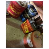 Three metal gas cans, two or 5 gallon and one is