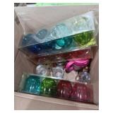 Three sets of colorful glasses glass mugs and