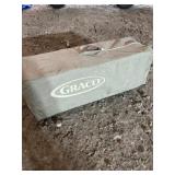 Graco Pack 'n Play portable playard stored in its