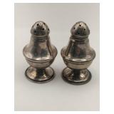 Silver salt and pepper shakers Marked Sterling.