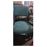 Wooden arm chair with green upholstery