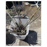 Fishing poles and reels in plastic waste bin