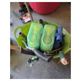 Garden tools and Miracle grow in a plastic basket
