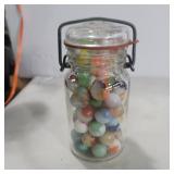 Glass spice jar full of marbles