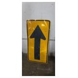 Directional arrow road sign has some damage