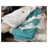 Various sewn linen and lace tablecloths and