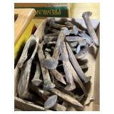 Broken ax head and several railroad spikes