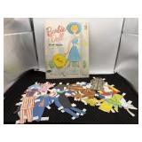 Barbie doll cut outs with lots of clothing.