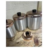 brushed aluminum canisters with a copper-colored