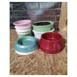 Group of assorted cat or dog feeding dishes.