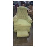 Green upholstered chair with matching stool