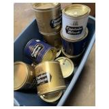 Tote of Captain Black coffee tins