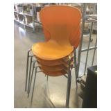 4 orange plastic chairs made in ECC