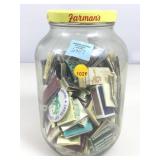 Matchbooks and pin collection in Pickle jar