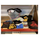 Bin of assorted clothing. Jackets, tshirts and