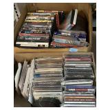 Assorted CDs, DVDs, and VHS tapes.