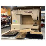 ELNA sewing machine with accessories in carrying