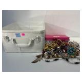 Metal bin with contents. Religious pendants and