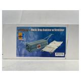 Model medic drop canister with stretcher in box.