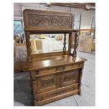 Antique wooden dresser with mirror and key.