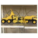 3 plastic toy tractor trucks.