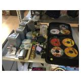RCA speakers, Binder of assorted DVDs, Delphi XM