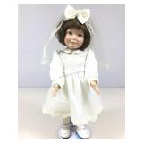 Collectible first communion doll on stand