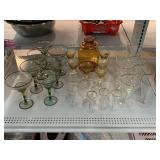 Amber glass jar with lid and assorted stemware