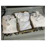 Assorted white T-Shirts, towels, and decorative