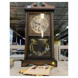 Wood cased Alaron all day clock with key. 24x12x6